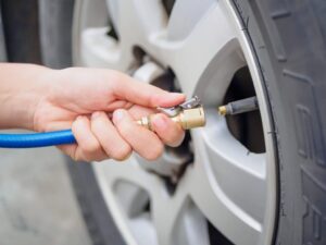 Filling up tyre pressure with blue hose
